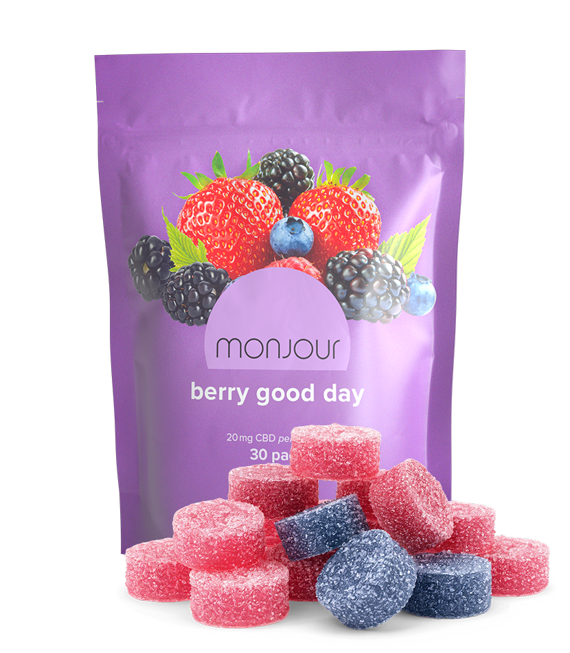 A purple pouch of Monjour Berry Good Day with a pile of gummies.